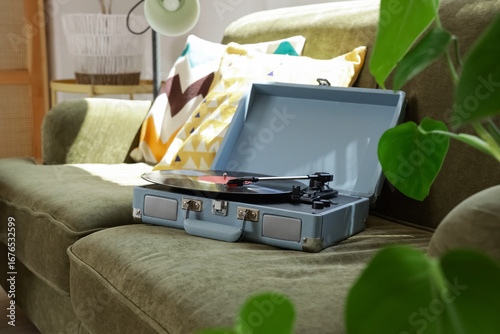 Record player on green sofa...