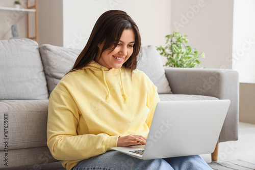 Beautiful young woman using...