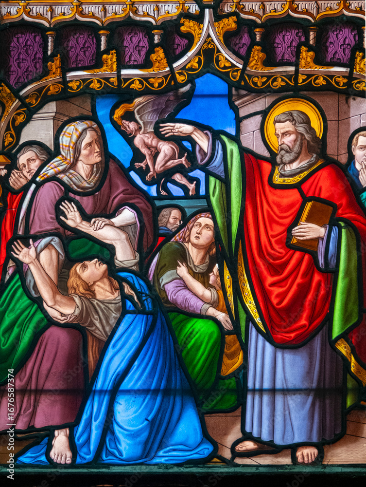 Fototapeta premium Stained glass (19th century) of Saint Peter exorcising a woman possessed by a devil.