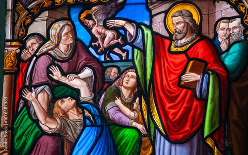 Stained glass (19th century) of Saint Peter exorcising a woman possessed by a devil.