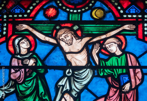 Stained glass (19th century) of Jesus Christ crucified on the cross represented with Marie and Saint John.