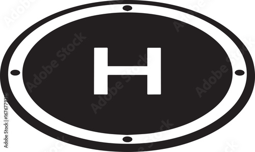  Close-up view of a circular helipad marking featuring a prominent 'H' symbol, indicating a designated helicopter landing area. 