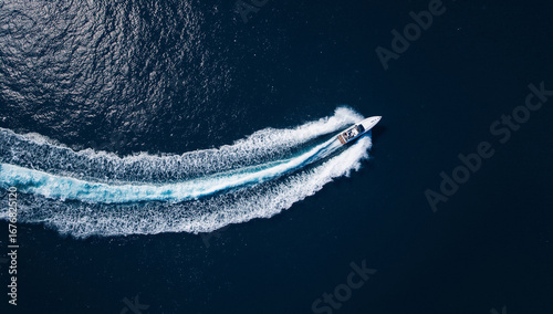Wallpaper Mural Aerial view of a boat speeding through the ocean, creating a white wake. Torontodigital.ca