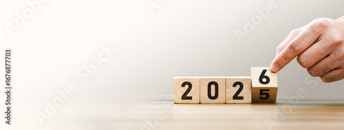 Transitioning from 2025 to 2026 with wooden blocks symbolizing target business for the upcoming year. This represents planning, investment, and innovation as ideas move from the end of 2025 new year