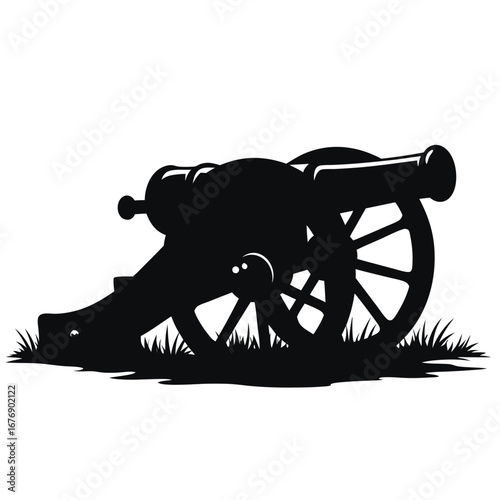 Black silhouette of an antique cannon on grass artillery