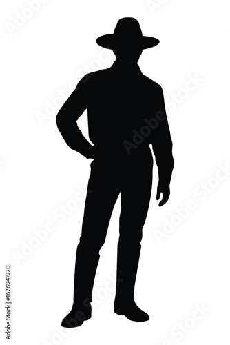 Fotografija Silhouette of a cowboy standing with hand on hip