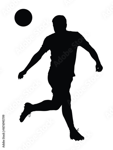 Silhouette of a soccer player kicking a ball
