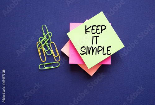 Keep it Simple symbol. Concept words Keep it Simple on sticky notes. Beautiful deep blue background. Business and Keep it Simple concept. Copy space.