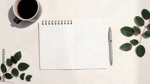 Blank notebook with leaves and coffee