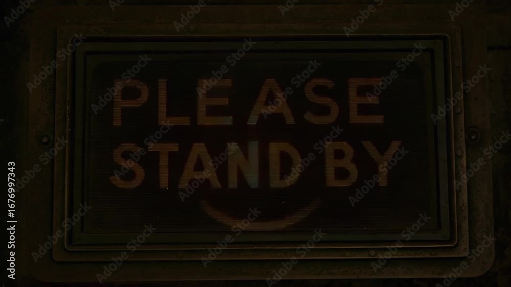 Vintage, illuminated sign, requesting people to stand by.