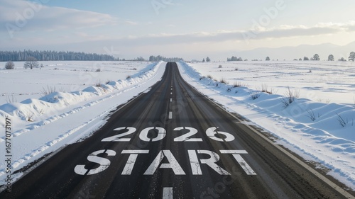 Long straight black asphalt road covered in snow, words 