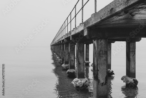 A Long Pier on a Calm, Misty Day in Black and White