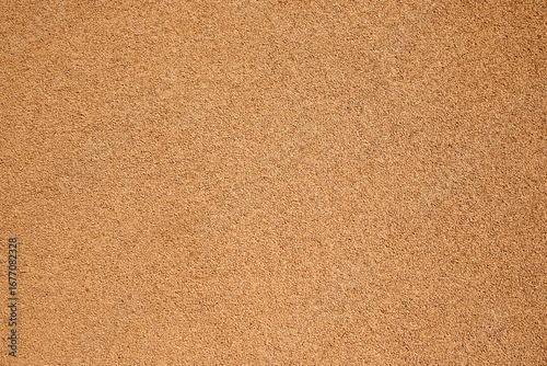 beige light brown rubber flooring for treadmill flooring on the court texture and seamless background. rubber coating of run track, playground or sports ground texture background.