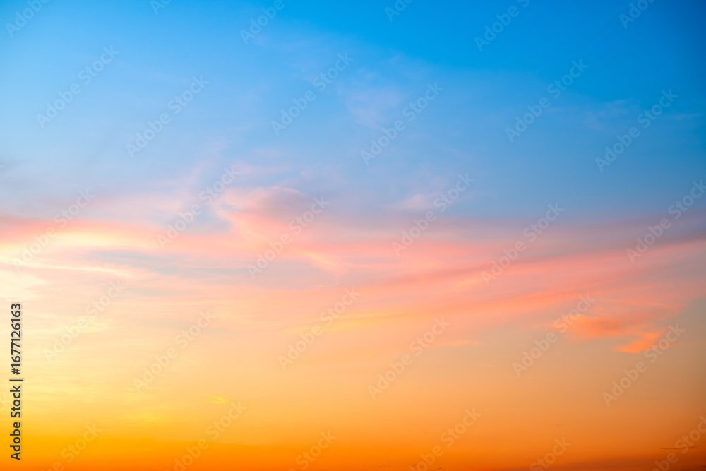 Obraz premium Beautiful , luxury soft gradient orange gold clouds and sunlight on the blue sky perfect for the background, take in evening,Twilight, Large size, high definition landscape photo