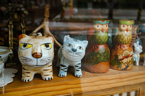 A Group of Ceramic Figurines of a Tiger and Owls in a Shop