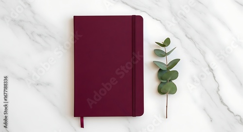 Elegant deep red notebook for daily thoughts or work planning, beautifully presented on marble