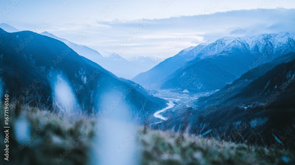Fototapeta premium A Serene and Beautiful Mountain Landscape Featuring a Pristine River and Tall SnowCapped Peaks