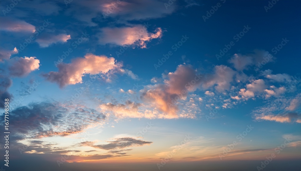 Fototapeta premium a serene sky with a few scattered clouds reflecting the soft colors of dawn the clouds