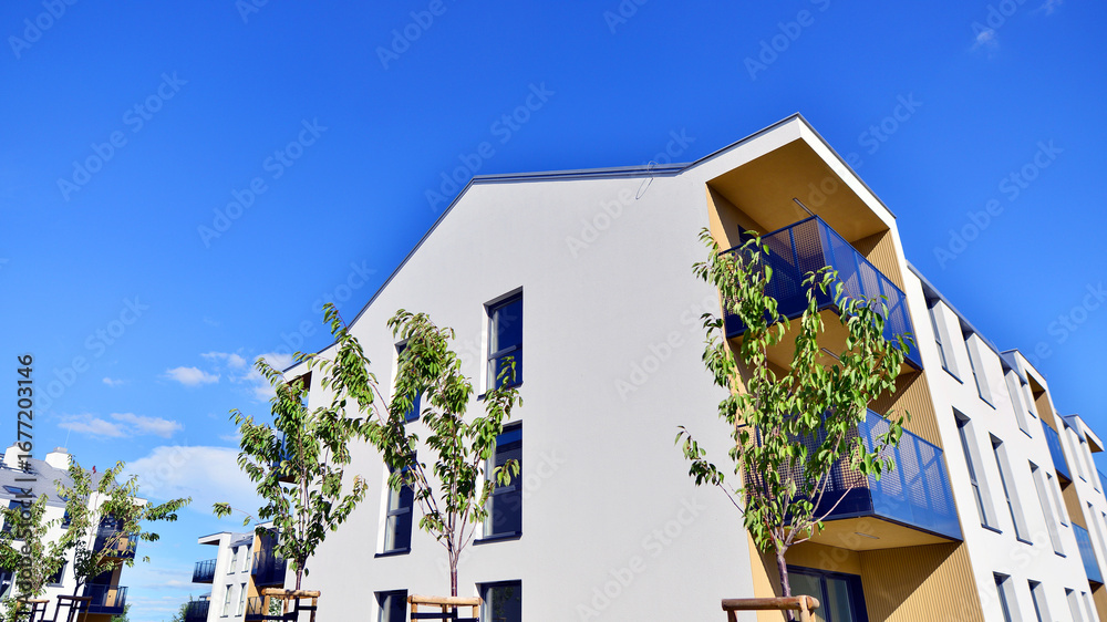 Fototapeta premium European residential architecture harmonizing with nature. Eco-friendly living in city with greens. Eco apartment building saving energy and fresh air concept. 
