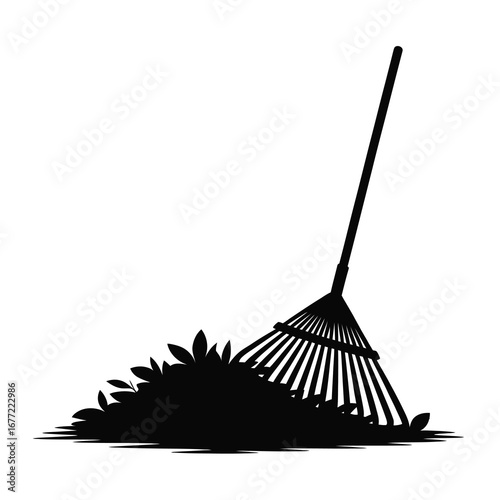 Silhouette of a leaf rake gathering autumn leaves for garden cleanup