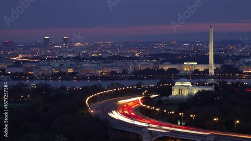 The metropolitan skyline of national capital at nightfall with vehicular movement trails on major highway