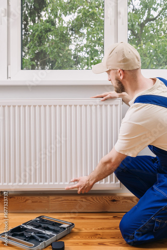 Home heating radiator installation and maintenance by repair technician indoors