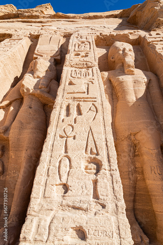 Photos Detail of the facade of the temple of Hator and Nefertari in the archeological site of Abu Simbel, Egypt, with symbols and hieroglypics and statues made of stone