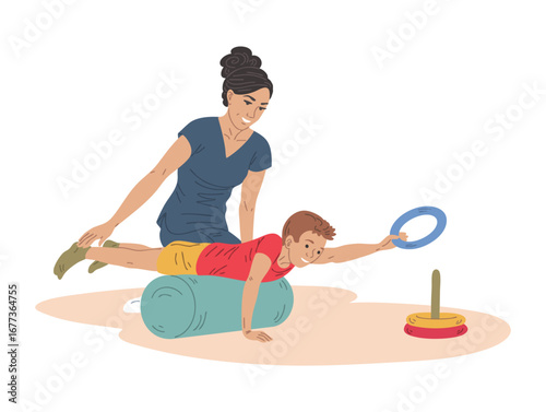 Physiotherapist helps boy on therapy roller reaching toy pyramid