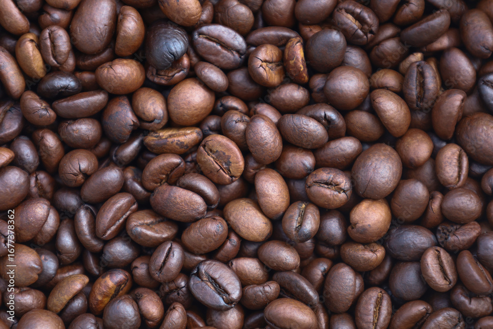 Naklejka premium Photo of Big pile of fresh roasted coffee beans close up. Food photo for backdrops or recipes