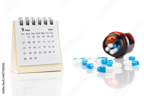 Medication schedule and treatment reminder concept. 2025 September calendar with pills and drug bottle for daily healthcare isolated on white background.