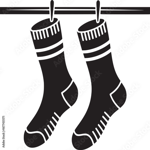 Two black socks hanging on a clothesline with clothespins in a minimalist black and white image style