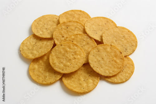 Crispy round corn chips stacked on white surface ready for a tasty crunchy bite