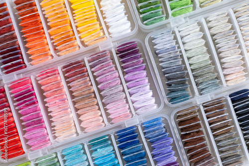 Colorful Spools of Thread Organized by Shade in Plastic Storage Boxes
