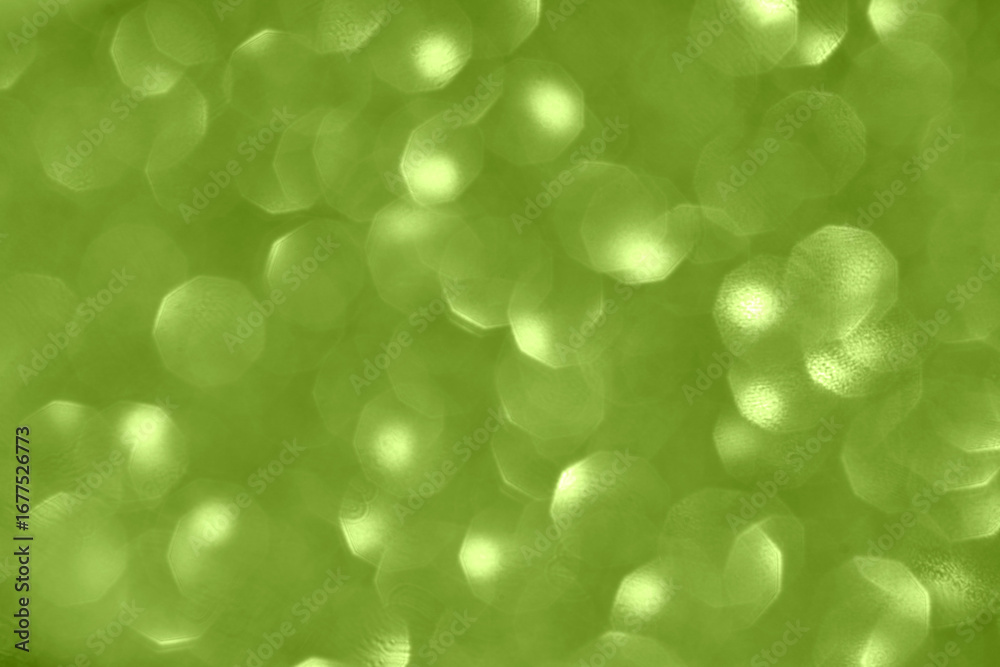 Fototapeta premium Green bokeh background with circular light patterns and soft focus for textured abstract design.