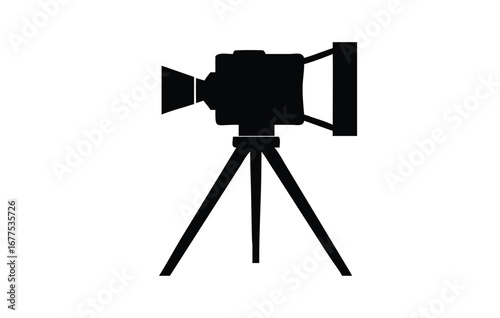 Silhouette of a vintage film camera mounted on a tripod for capturing moments