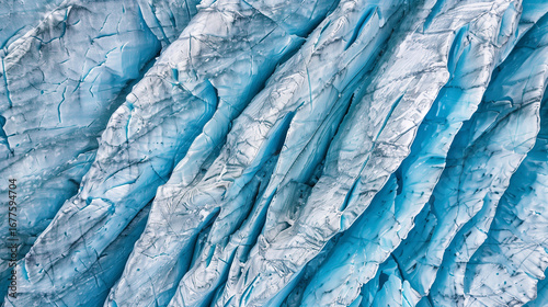 Wallpaper Mural Captured from above, this aerial view showcases the stunning patterns and colors of a glacier ice field, with deep crevasses and vibrant blue hues reflecting the sunlight Torontodigital.ca