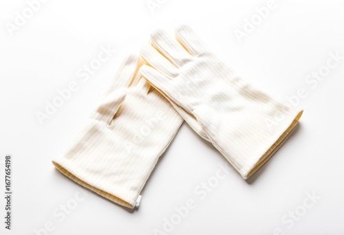 A pair of white gloves on a white surface.