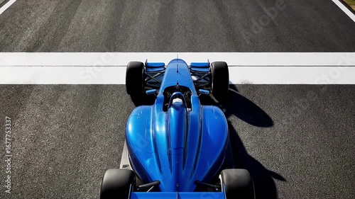 Blue race car accelerates on track highlighting speed and precision in aerial sequence