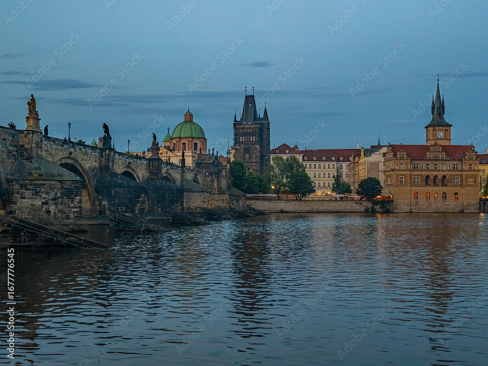 Fototapeta premium Sunset view of Charles bridge and Saint Salvator church in Pragu