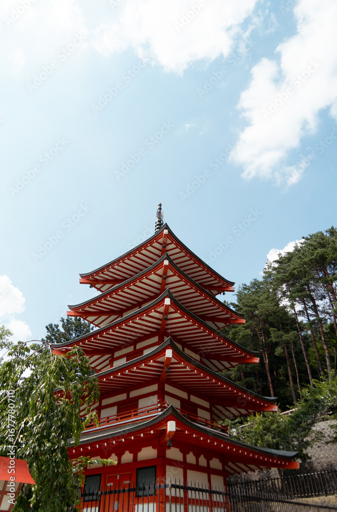 Naklejka premium Traditional Japanese pagoda under a blue sky. Travel to Japan. Chureito Pagoda