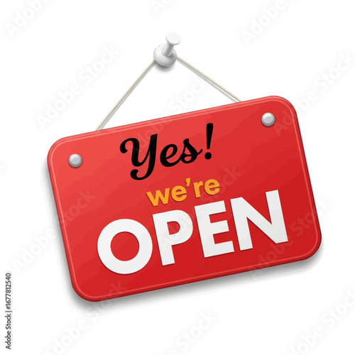A bright red rectangular sign with rounded corners, hanging from a white pushpin, announcing "Yes! we're OPEN" in stylized white and yellow lettering.
