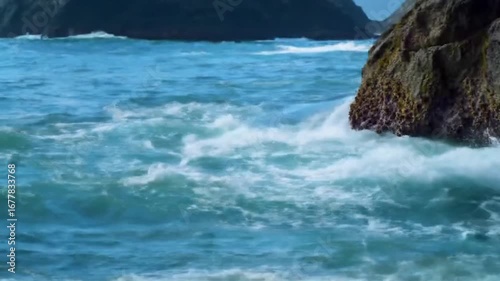 Ocean's Embrace: A dynamic moment as a turbulent ocean collides with coastal rocks, capturing nature's untamed power and the soothing embrace of the sea. 