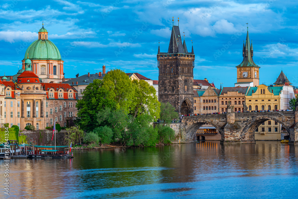 Obraz premium Sunset view of Charles bridge and Saint Salvator church in Pragu