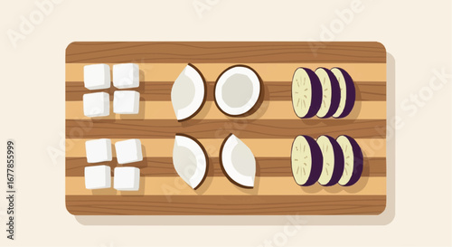 Chopped coconut, tofu, and eggplant on a wooden board.