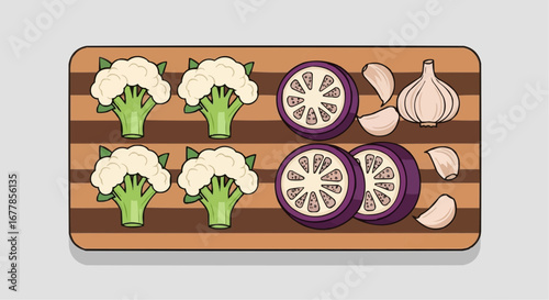 Chopped cauliflower, eggplant, and garlic on a wooden board.