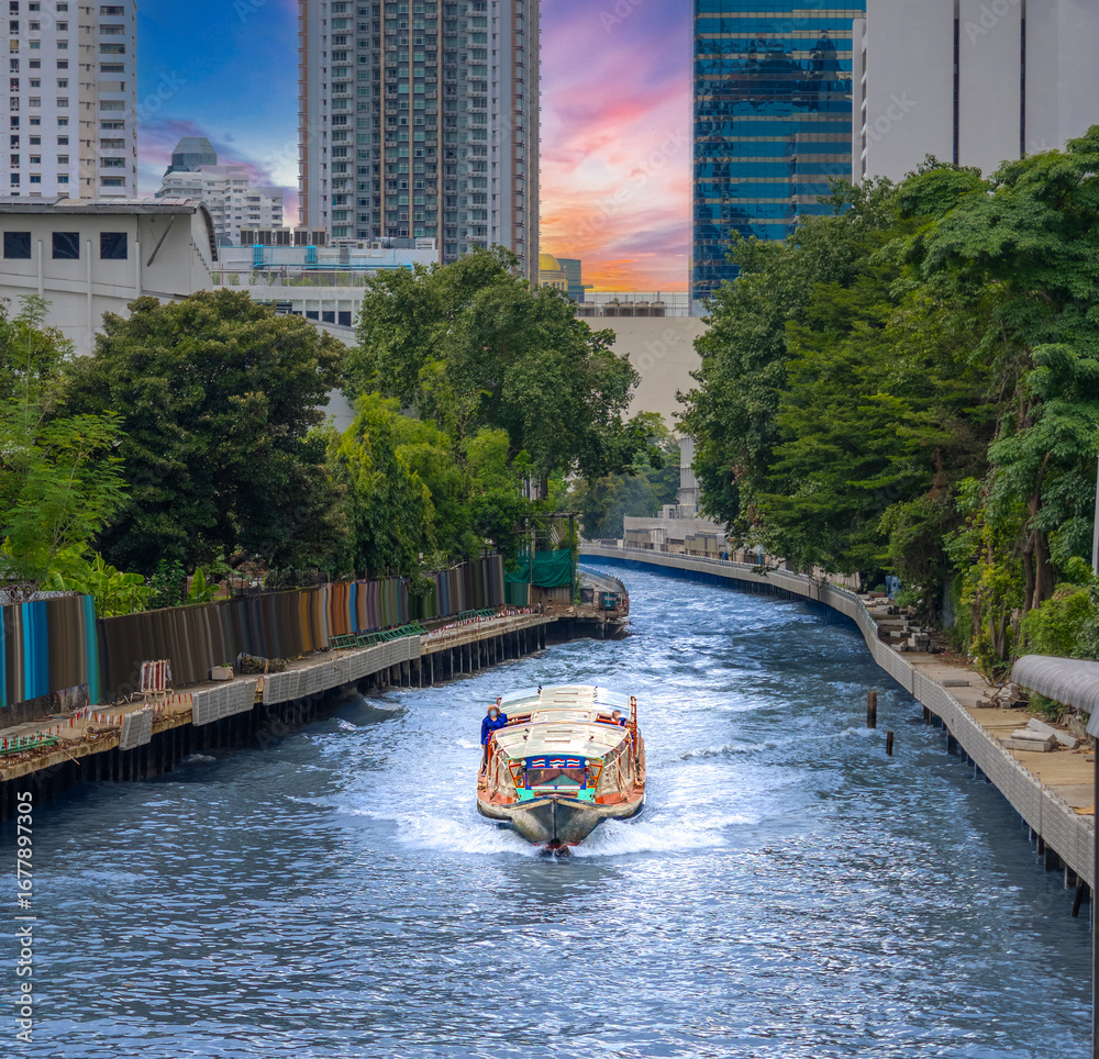 Fototapeta premium Ferry boat going through a Canal Khlong in Thai running from Asoke Soi 21 Sukhumvit Rd NANA to Siam and Platunam in BKK Bangkok Thailand