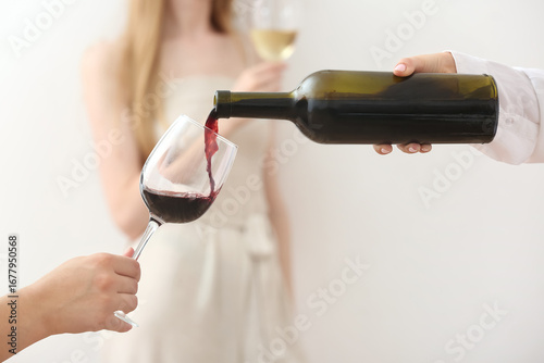 Woman pouring exquisite red...