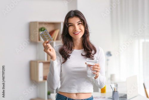 Smiling young woman holding...