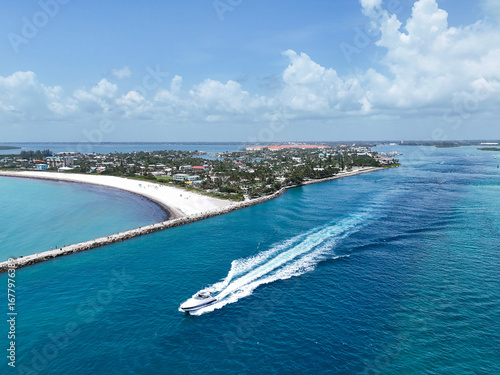 Aerial view of boat heading to sea in Fort Pierce Inlet on the Treasure Coast of Florida in St. Lucie County