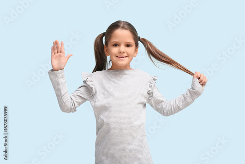 Cute little happy girl wavi...